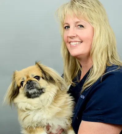 Ann holding small dog at Rainbow Animal Hospital Ann holding small dog at Rainbow Animal Hospital