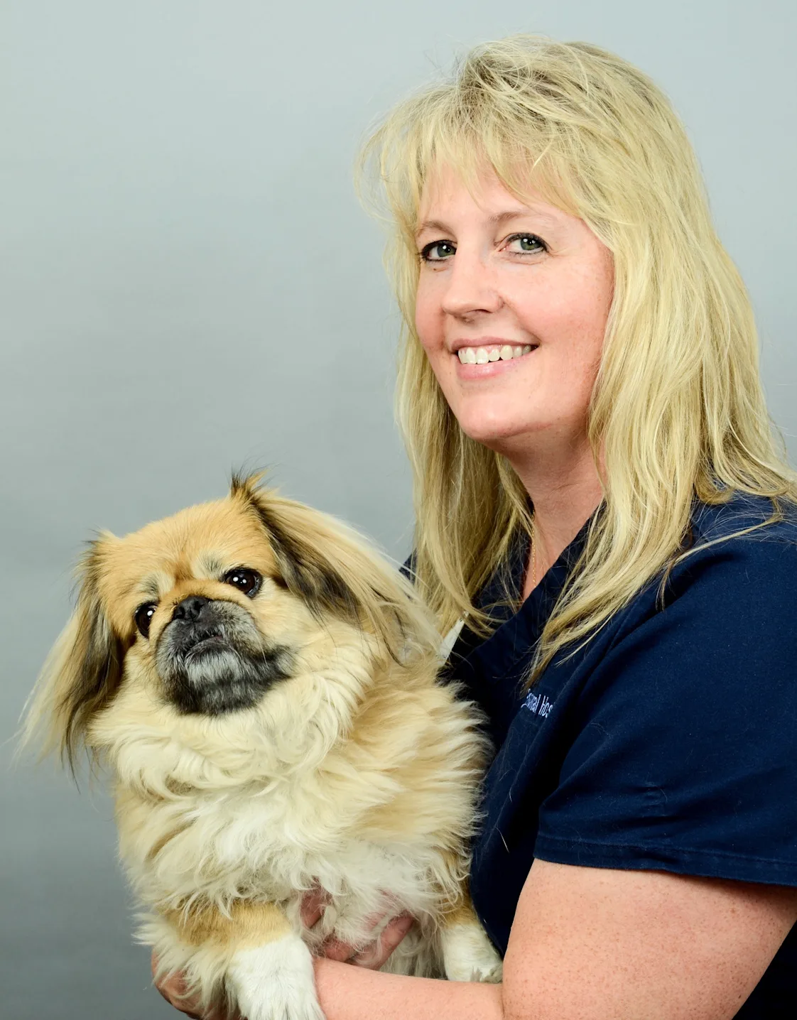Ann holding small dog at Rainbow Animal Hospital Ann holding small dog at Rainbow Animal Hospital