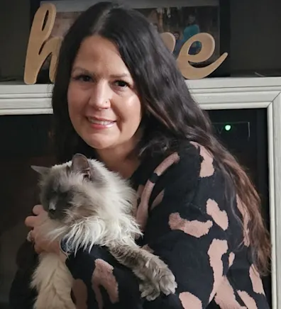 Tara from Midland Animal Clinic sitting at a desk Tara from Midland Animal Clinic sitting at a desk