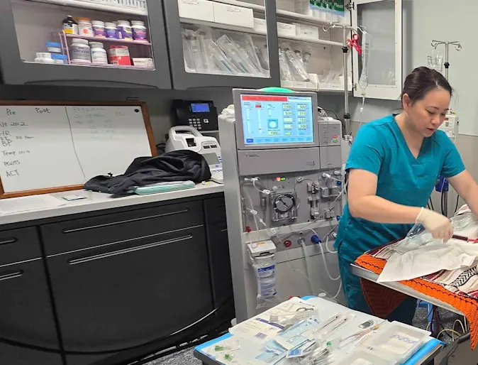 Staff standing in front of a monitor. Staff standing in front of a monitor.