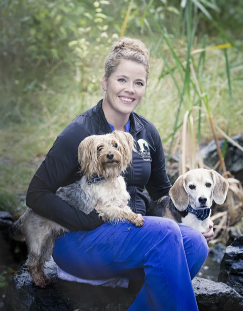 Amanda sitting with two small dogs