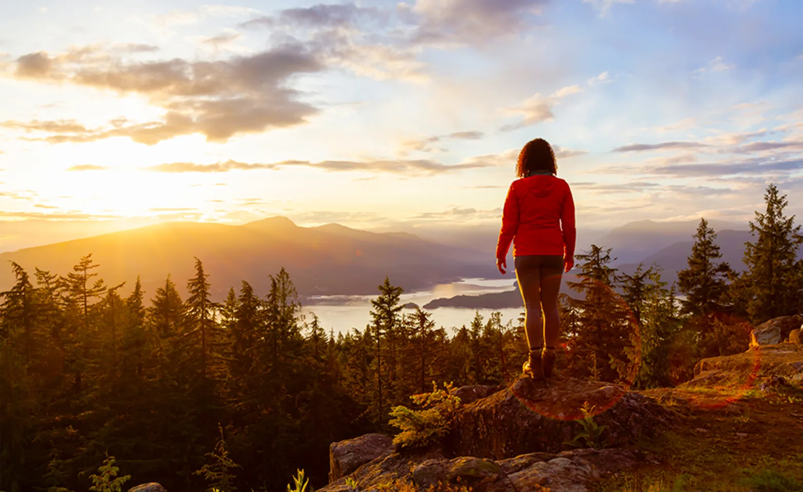 A person standing on top of a mountain on Bowen Island, BC.
