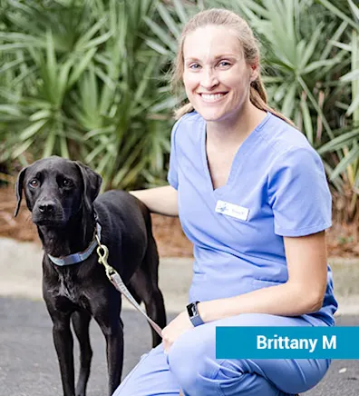Staff member with black dog Staff member with black dog