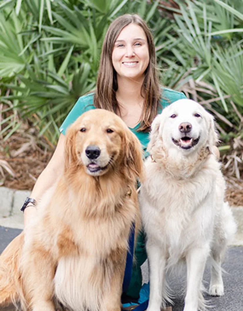 Dr. Beck with two golden retrievers 