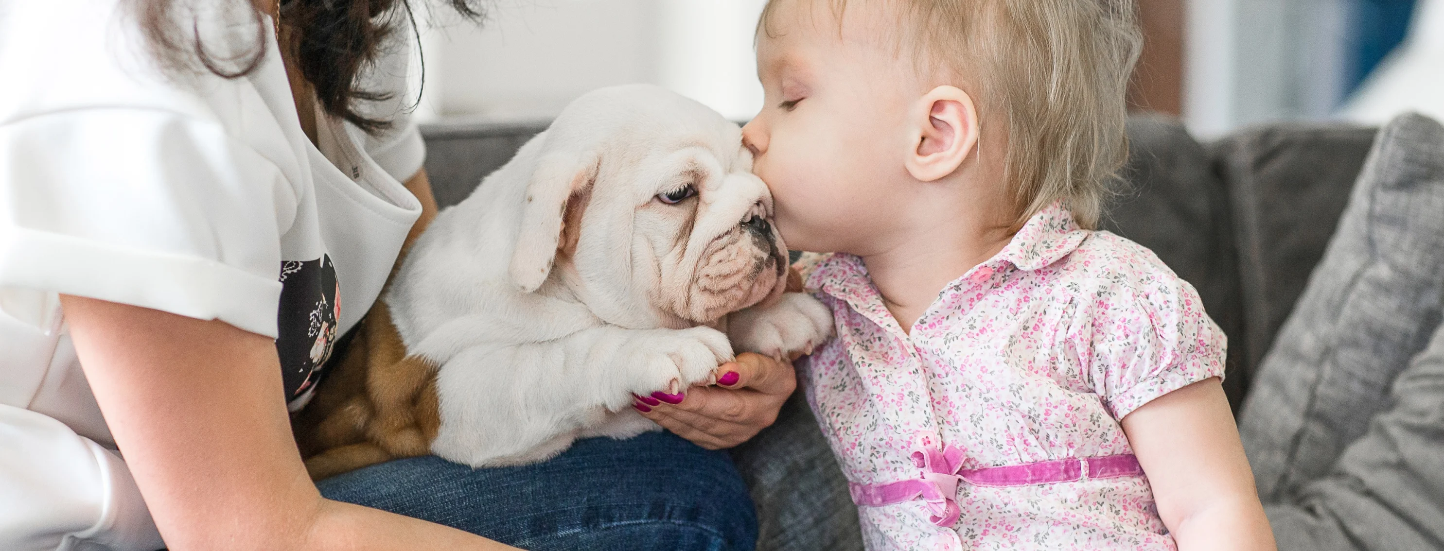 Baby kissing a puppy
