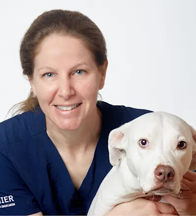 Dr. Sloane Robins holding a dog Dr. Sloane Robins holding a dog
