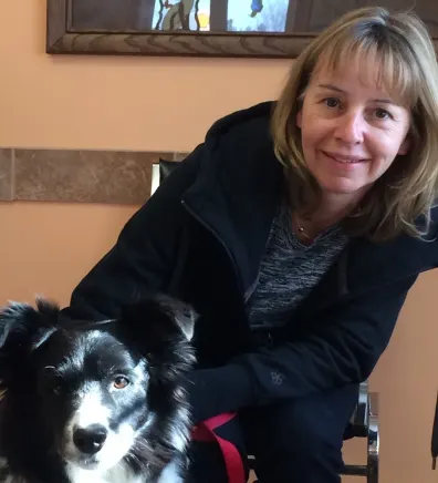 Anne, bookkeeper at Three Islands Veterinary Services, with Bandit the dog