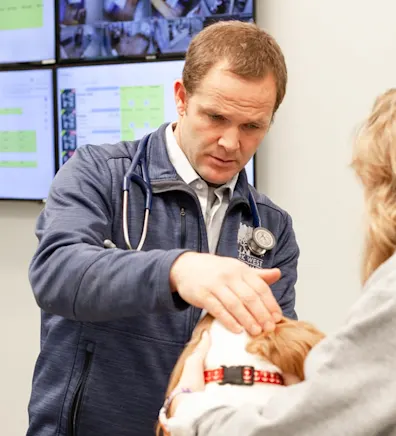Dr. Justin Butler examining a dog Dr. Justin Butler examining a dog