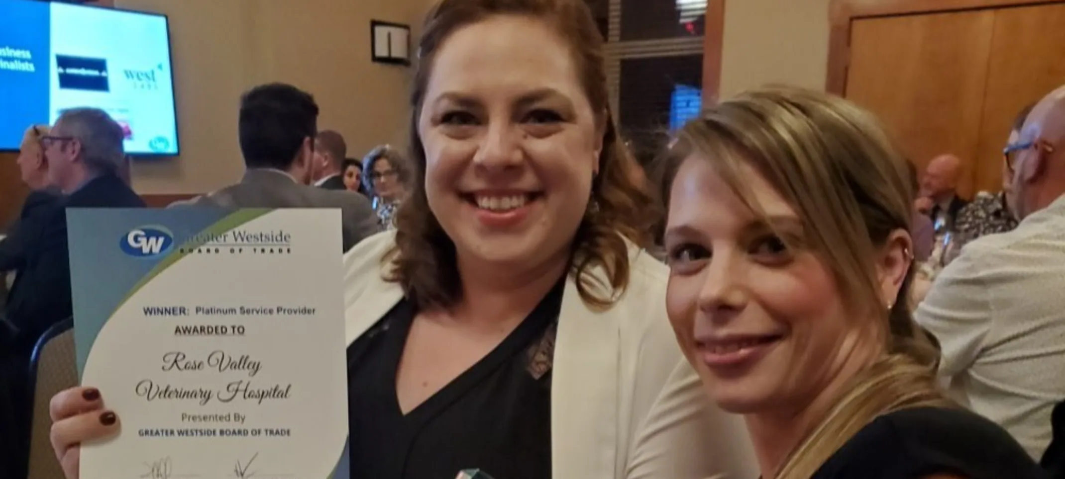 Staff holding awards Staff holding awards