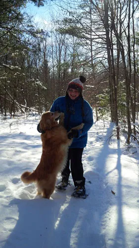 Dog with their owner in the snow