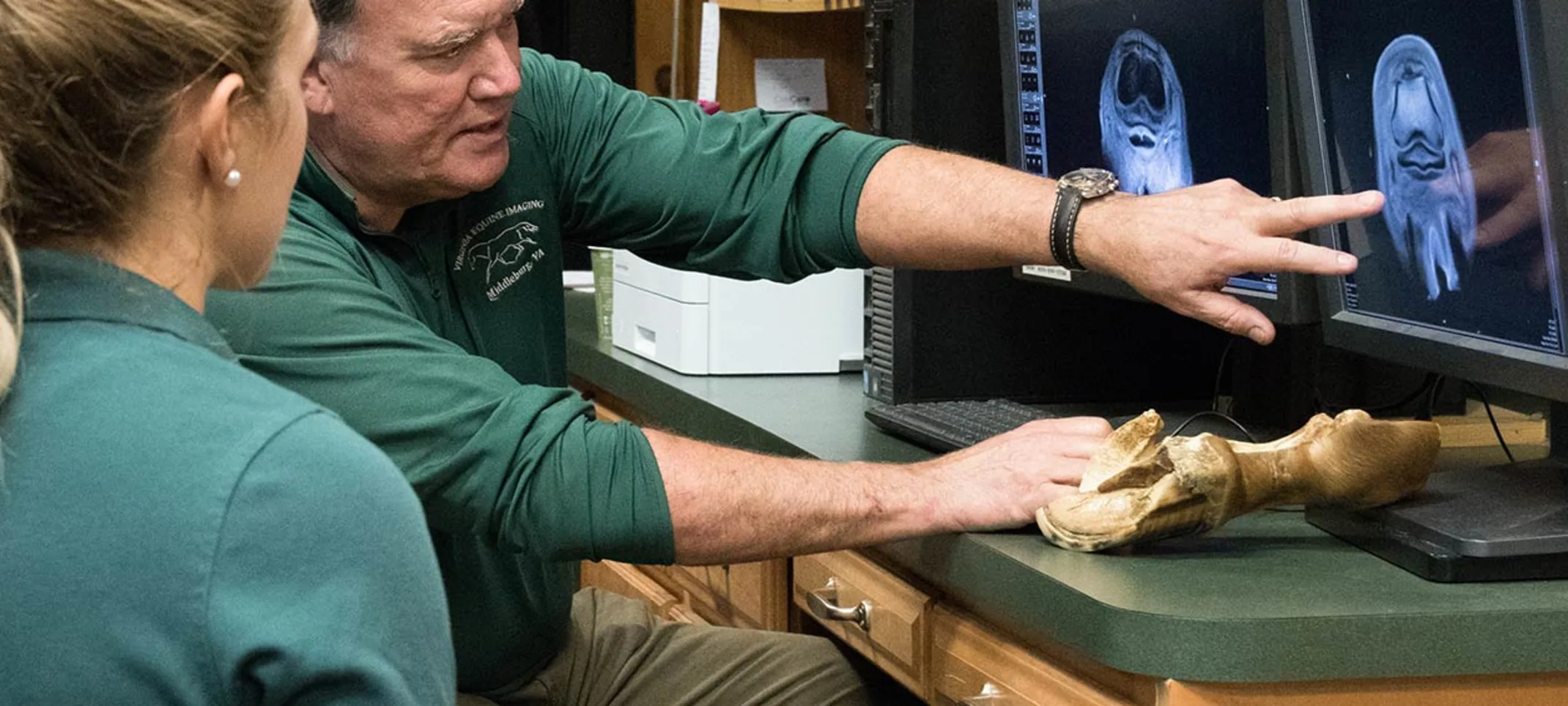 Staff members looking at x-rays on a computer Staff members looking at x-rays on a computer