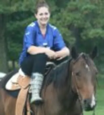 Rochina Ahrens' staff photo from Shinnecock Animal Hospital where she is outside saddled up on a brown horse. Rochina Ahrens' staff photo from Shinnecock Animal Hospital where she is outside saddled up on a brown horse.