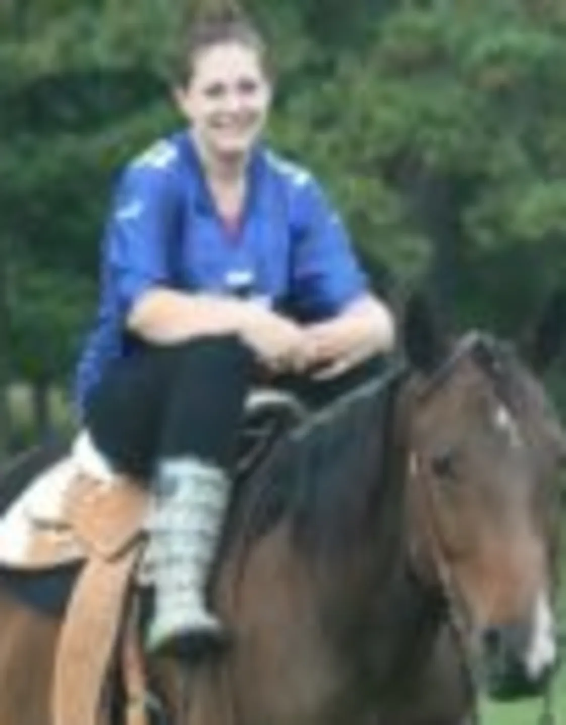 Rochina Ahrens' staff photo from Shinnecock Animal Hospital where she is outside saddled up on a brown horse. Rochina Ahrens' staff photo from Shinnecock Animal Hospital where she is outside saddled up on a brown horse.