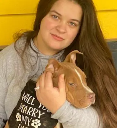 Cheyanne of the Paw Patch Place holding a brown dog Cheyanne of the Paw Patch Place holding a brown dog