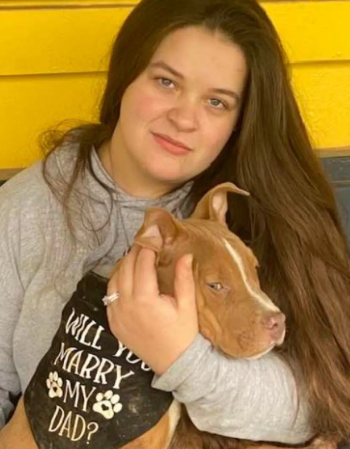 Cheyanne of the Paw Patch Place holding a brown dog Cheyanne of the Paw Patch Place holding a brown dog