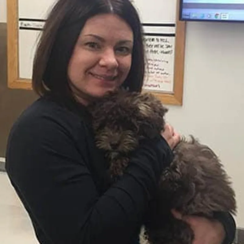 Erin - Veterinary Assistant holding a curly haired black dog at Animal Care Clinic West & Metro Cat Hospital Erin - Veterinary Assistant holding a curly haired black dog at Animal Care Clinic West & Metro Cat Hospital