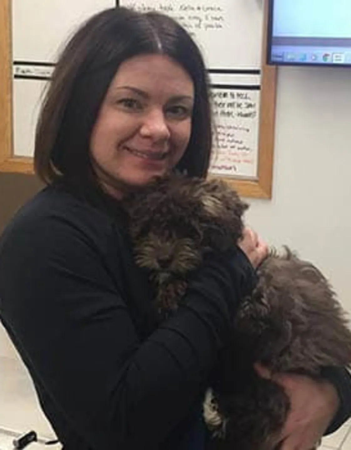 Erin - Veterinary Assistant holding a curly haired black dog at Animal Care Clinic West & Metro Cat Hospital Erin - Veterinary Assistant holding a curly haired black dog at Animal Care Clinic West & Metro Cat Hospital