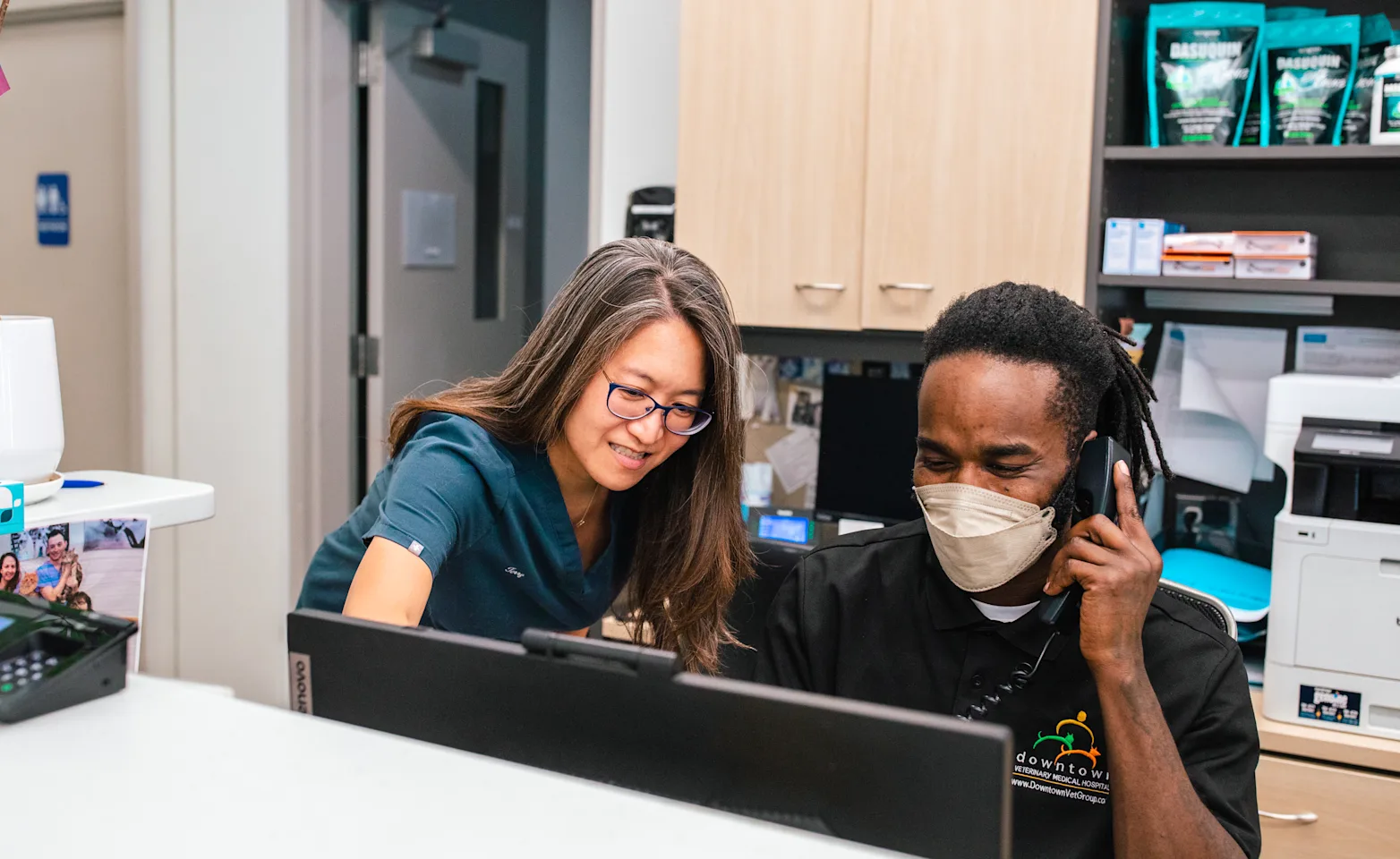 Two veterinary professionals working together at a desk Two veterinary professionals working together at a desk