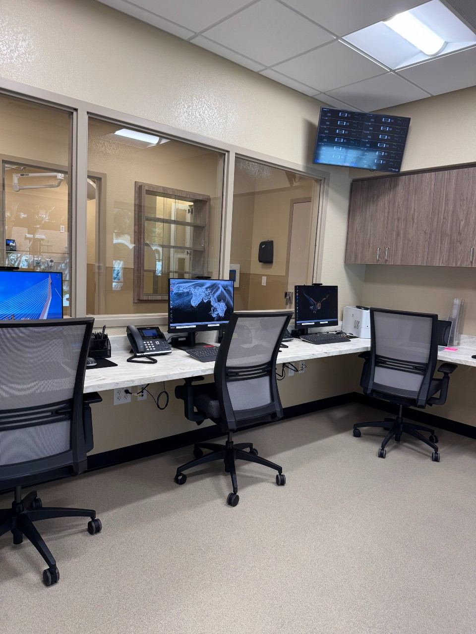 Back office lined with office chairs and monitors.