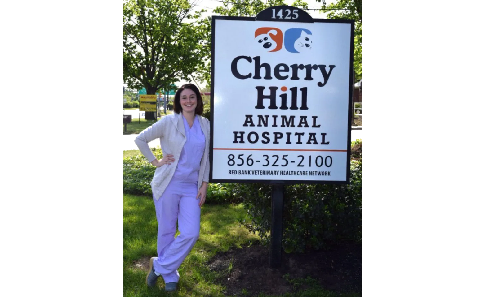 Staff standing next to Cherry Hill Animal Hospital sign
