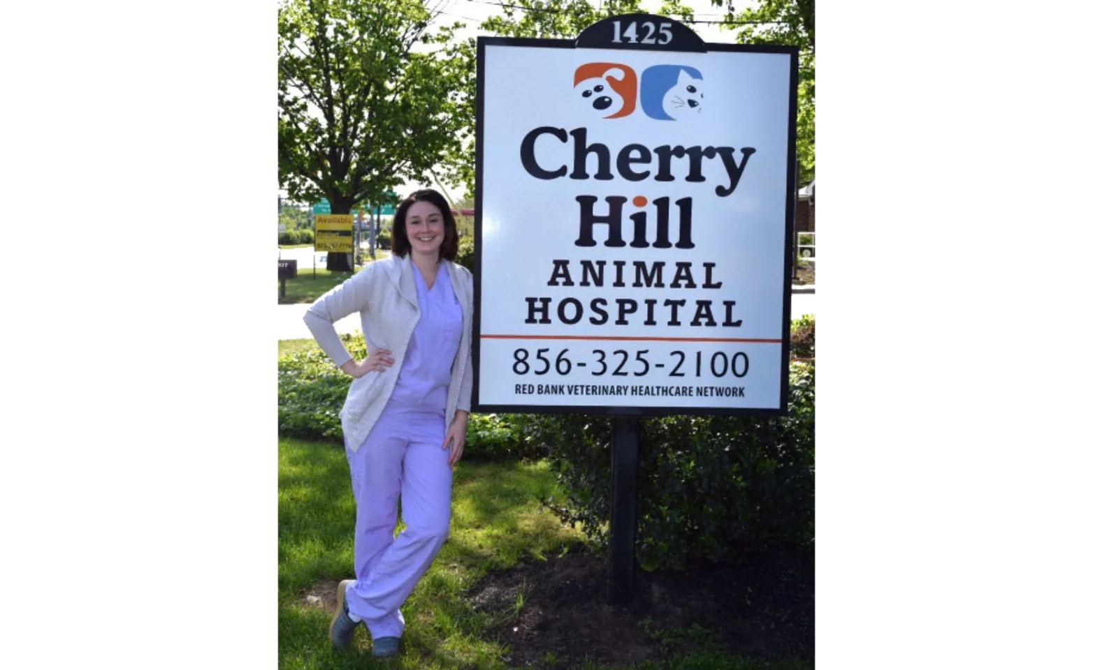 Staff standing next to Cherry Hill Animal Hospital sign Staff standing next to Cherry Hill Animal Hospital sign