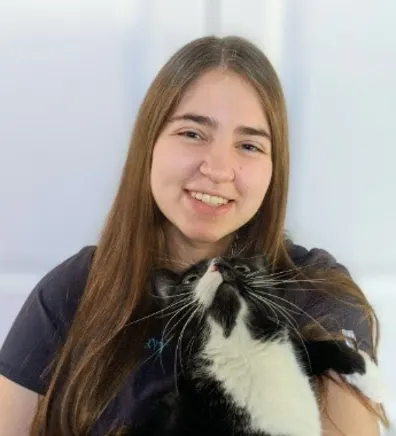 Shaine holding a small black and white cat