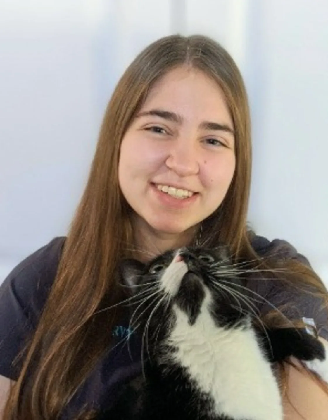 Shaine holding a small black and white cat Shaine holding a small black and white cat