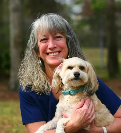 Stephanie H. holding dog outside by tree Stephanie H. holding dog outside by tree