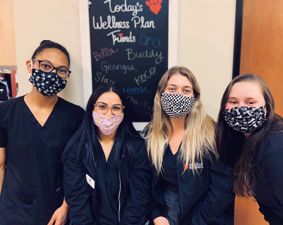 Group photo of 4 people with their masks on.