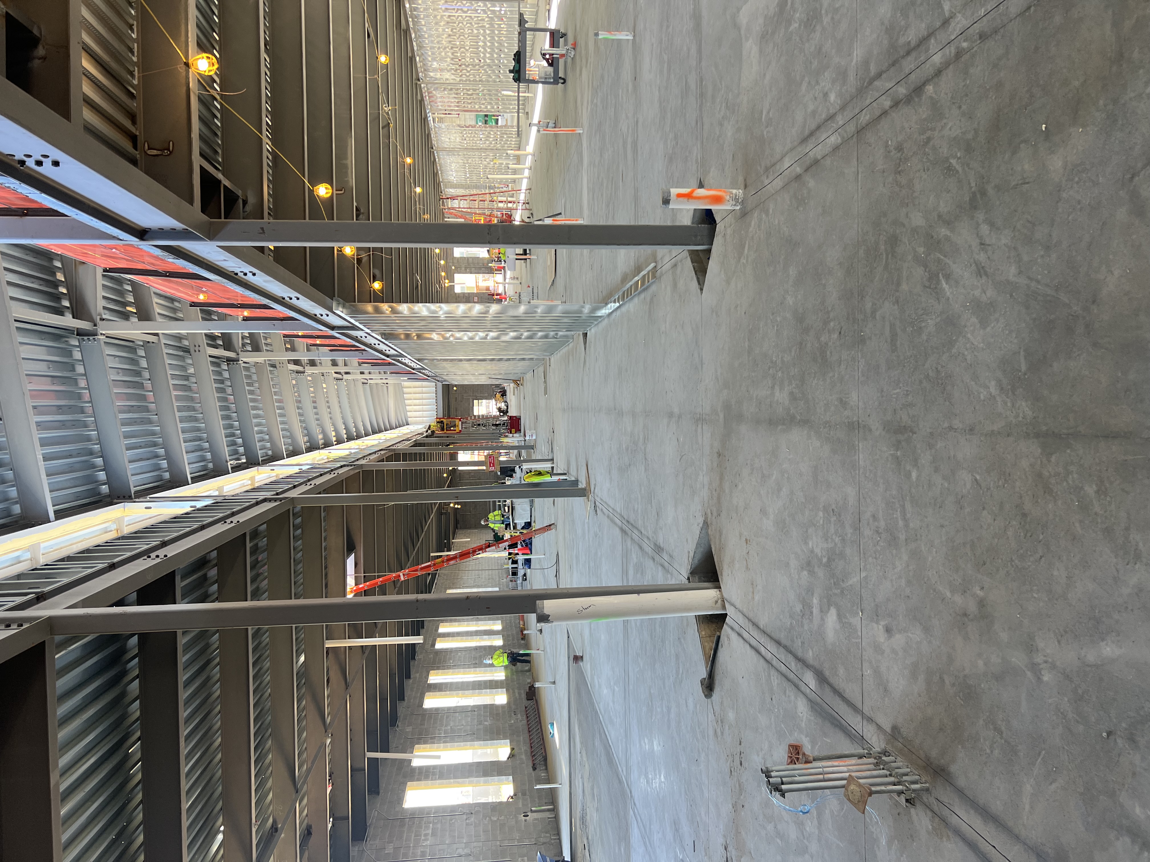 An inside view of the hallway being constructed inside the foundation. Beams are shown front and center. 