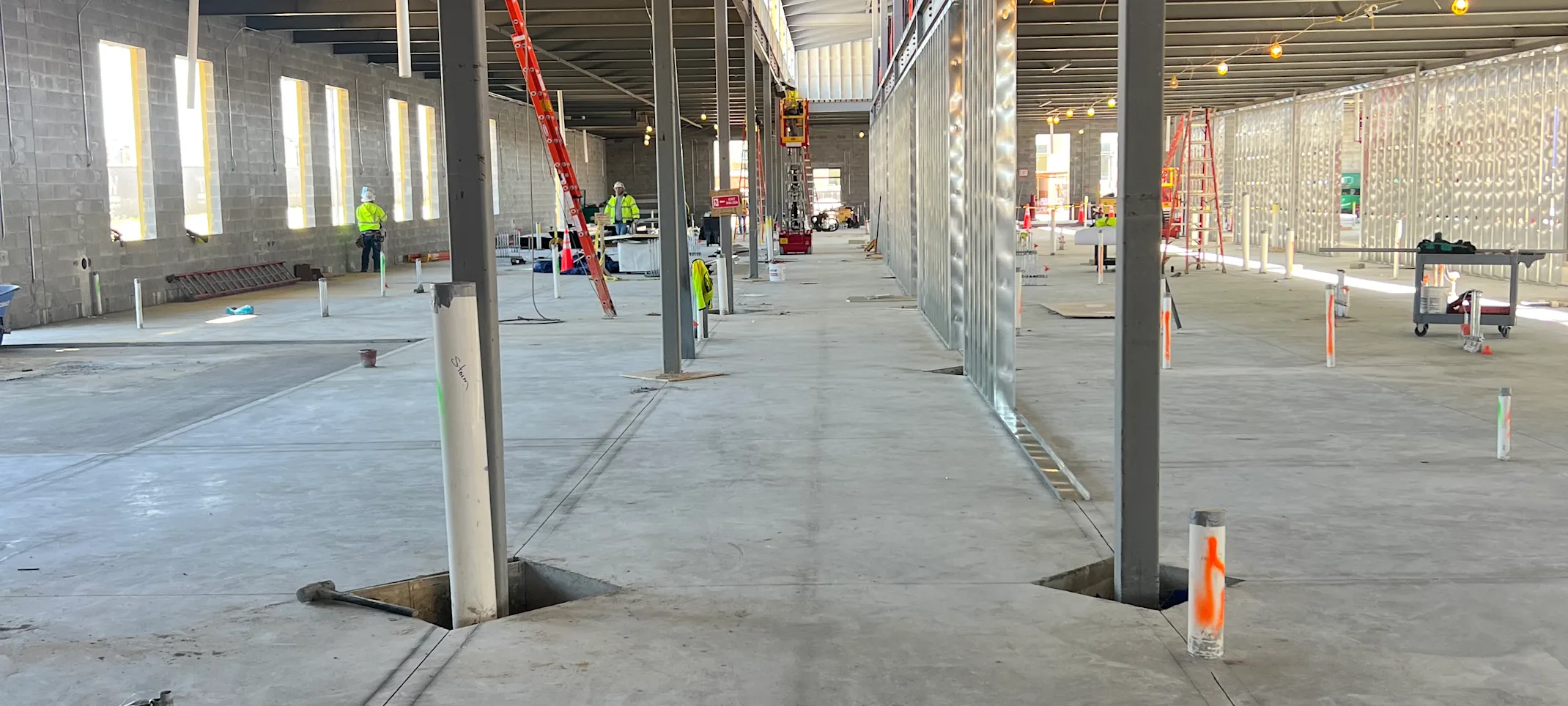 An inside view of the hallway being constructed inside the foundation. Beams are shown front and center. An inside view of the hallway being constructed inside the foundation. Beams are shown front and center.