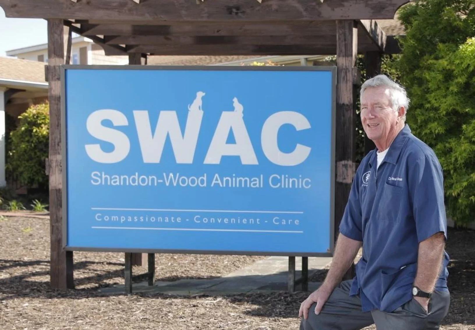 Dr. Atkinson standing next to SWAC sign Dr. Atkinson standing next to SWAC sign