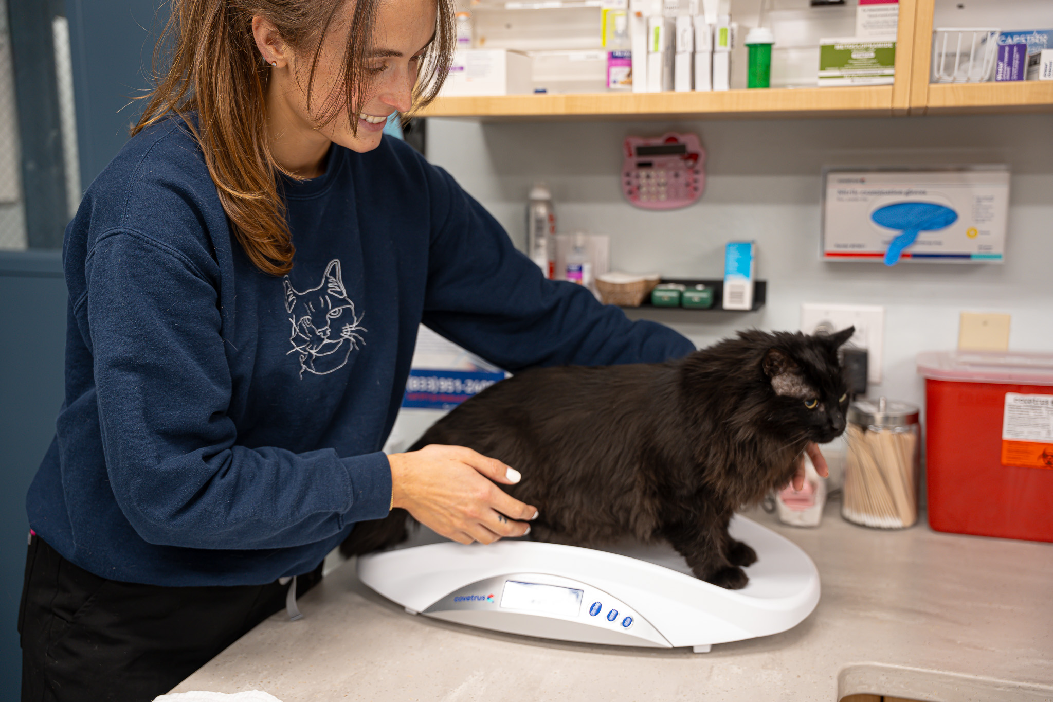 Staff member with a black cat named Lennie