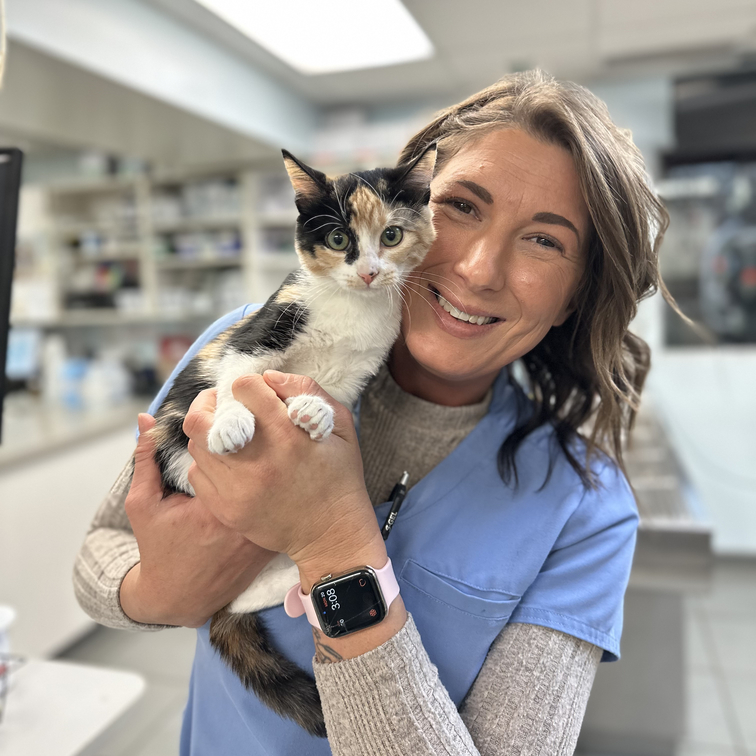 Our Staff Smiling with a Black & Brown Spotted Kitten