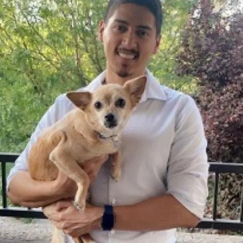 Dr. Mendez holding dog Dr. Mendez holding dog