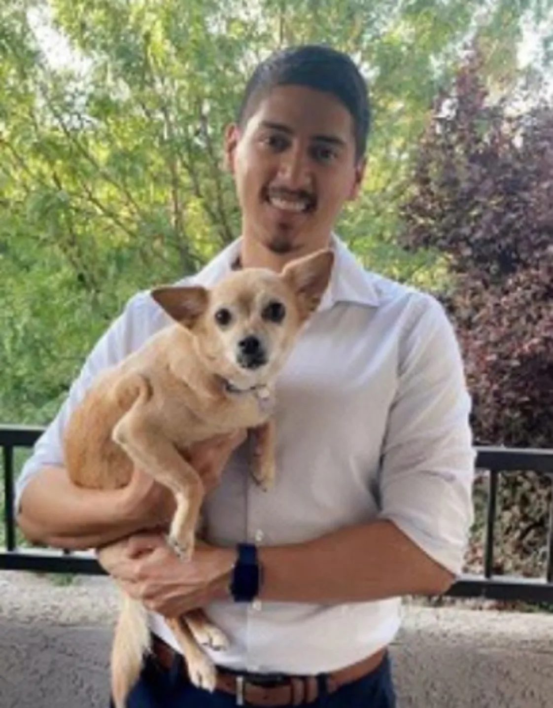 Dr. Mendez holding dog Dr. Mendez holding dog