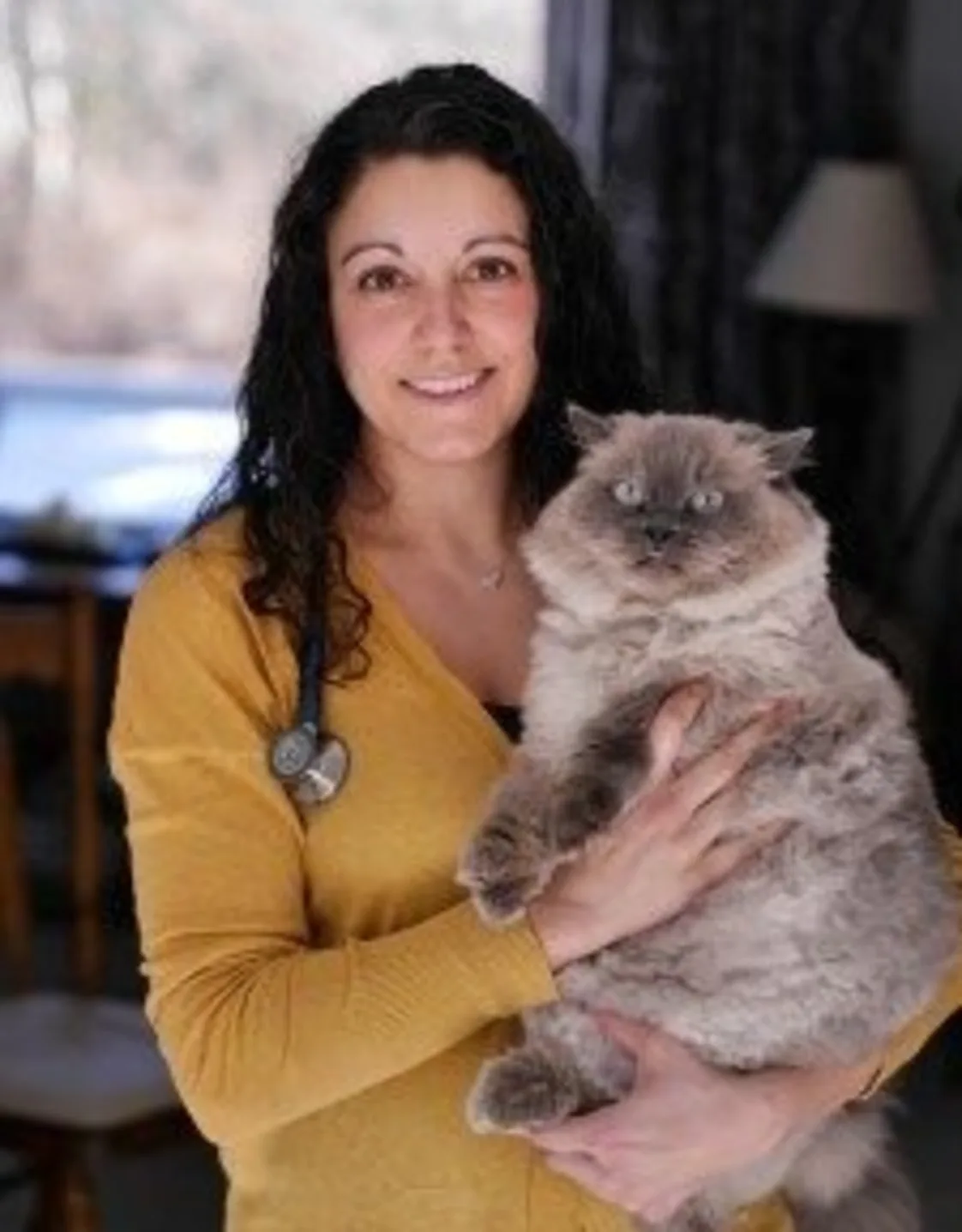 Dr. Jessica Dias of Northampton Veterinary Clinic inside a building, holding a cat Dr. Jessica Dias of Northampton Veterinary Clinic inside a building, holding a cat