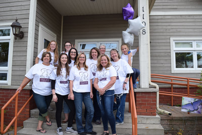 Staff posing outside clinic