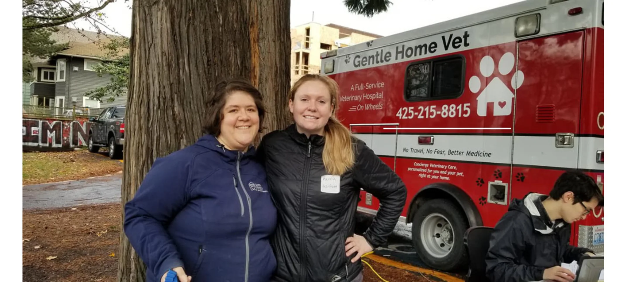 Gentle Home Vet red truck and two women smiling.