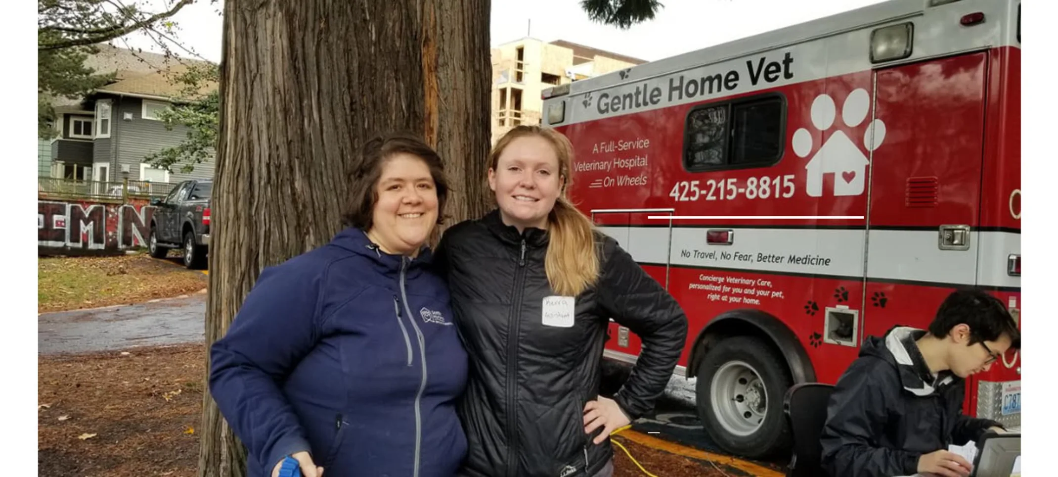 Gentle Home Vet red truck and two women smiling. Gentle Home Vet red truck and two women smiling.