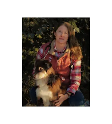 A photo of Dr. Austin posing with her dog A photo of Dr. Austin posing with her dog