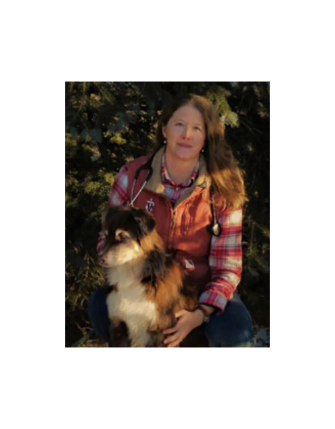 A photo of Dr. Austin posing with her dog A photo of Dr. Austin posing with her dog