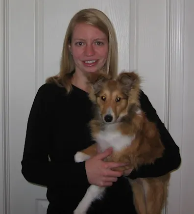 Crystal holding a tan and white dog Crystal holding a tan and white dog