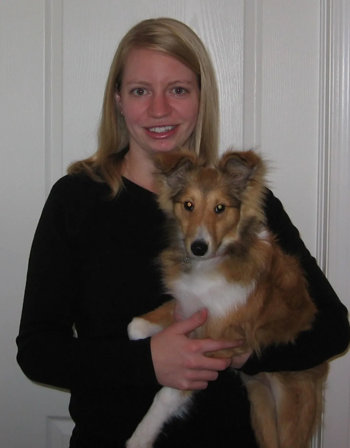 Crystal holding a tan and white dog Crystal holding a tan and white dog