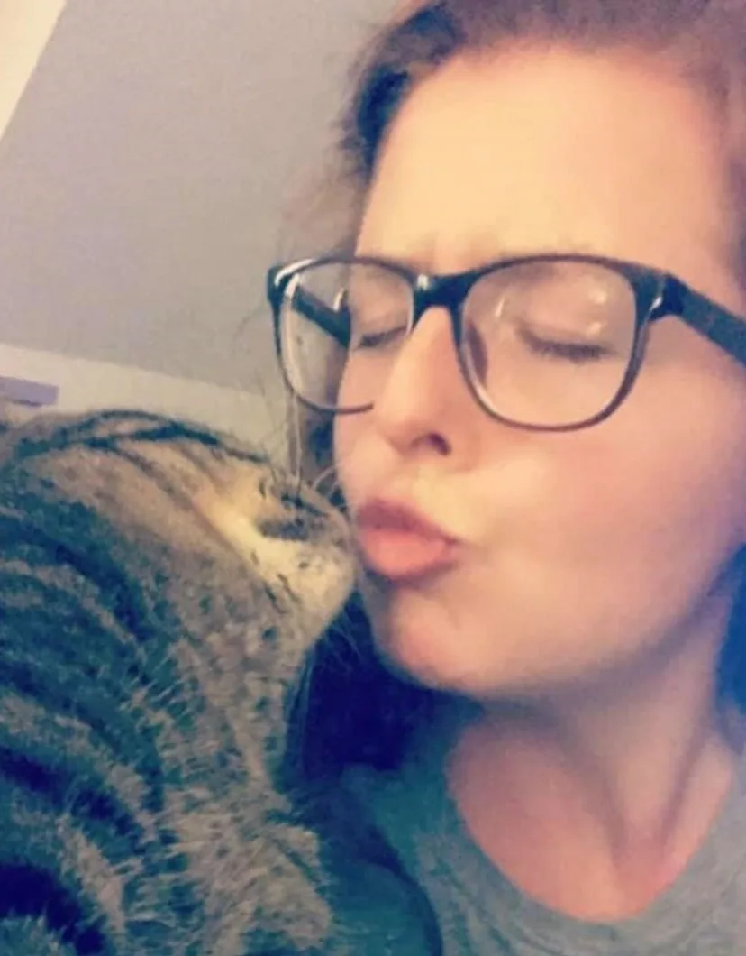 Morgan Ellis kissing a cat