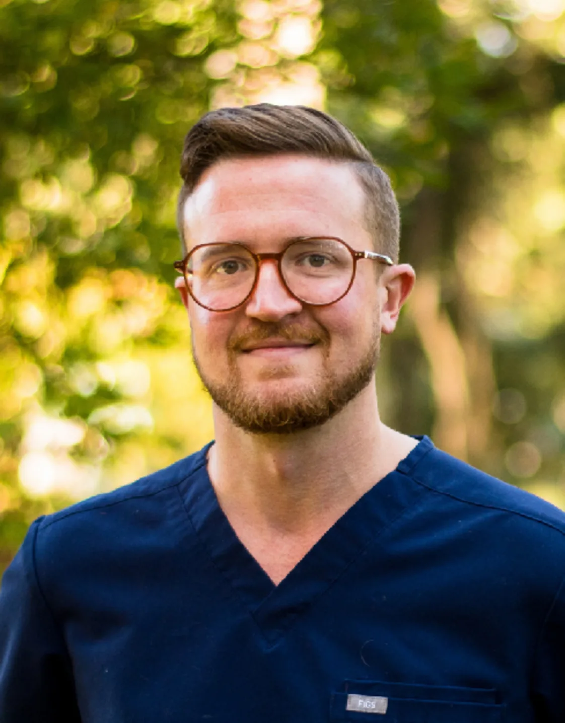 A photo of Dr. Kowal smiling against a background of greenery A photo of Dr. Kowal smiling against a background of greenery