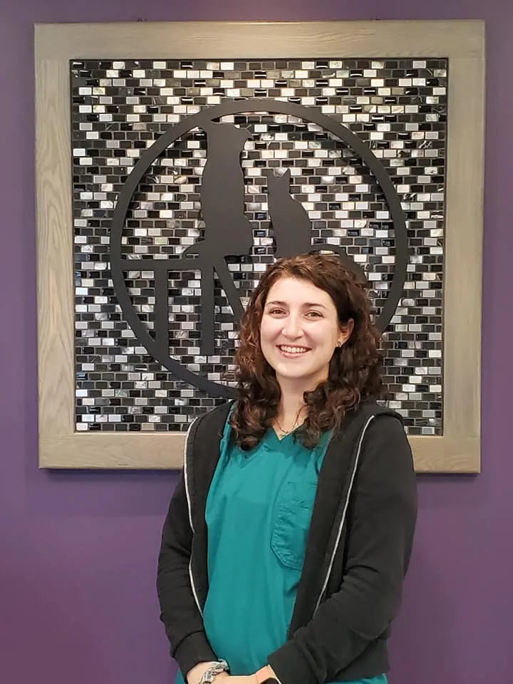 Emma in front of a purple wall