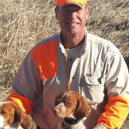 Mark A. McCann and two brown and white dogs