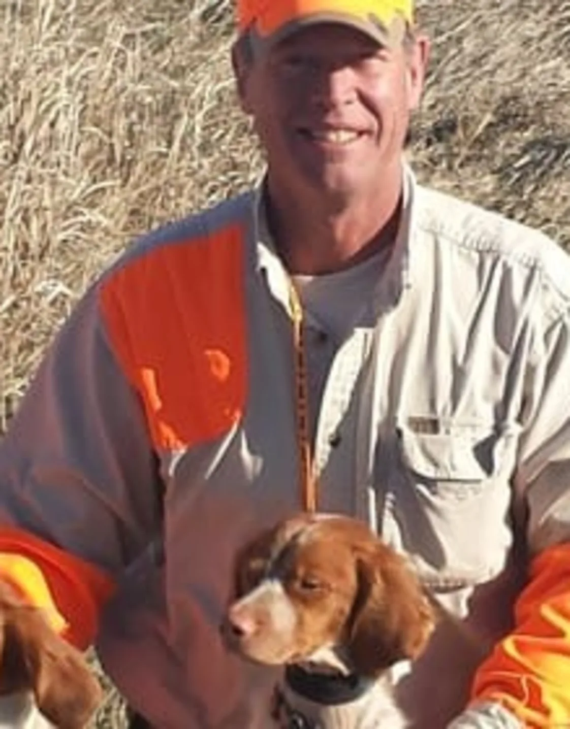 Mark A. McCann and two brown and white dogs Mark A. McCann and two brown and white dogs