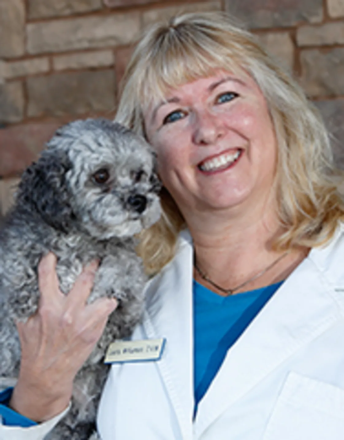 Dr. Laura Williamson holding small dog Dr. Laura Williamson holding small dog